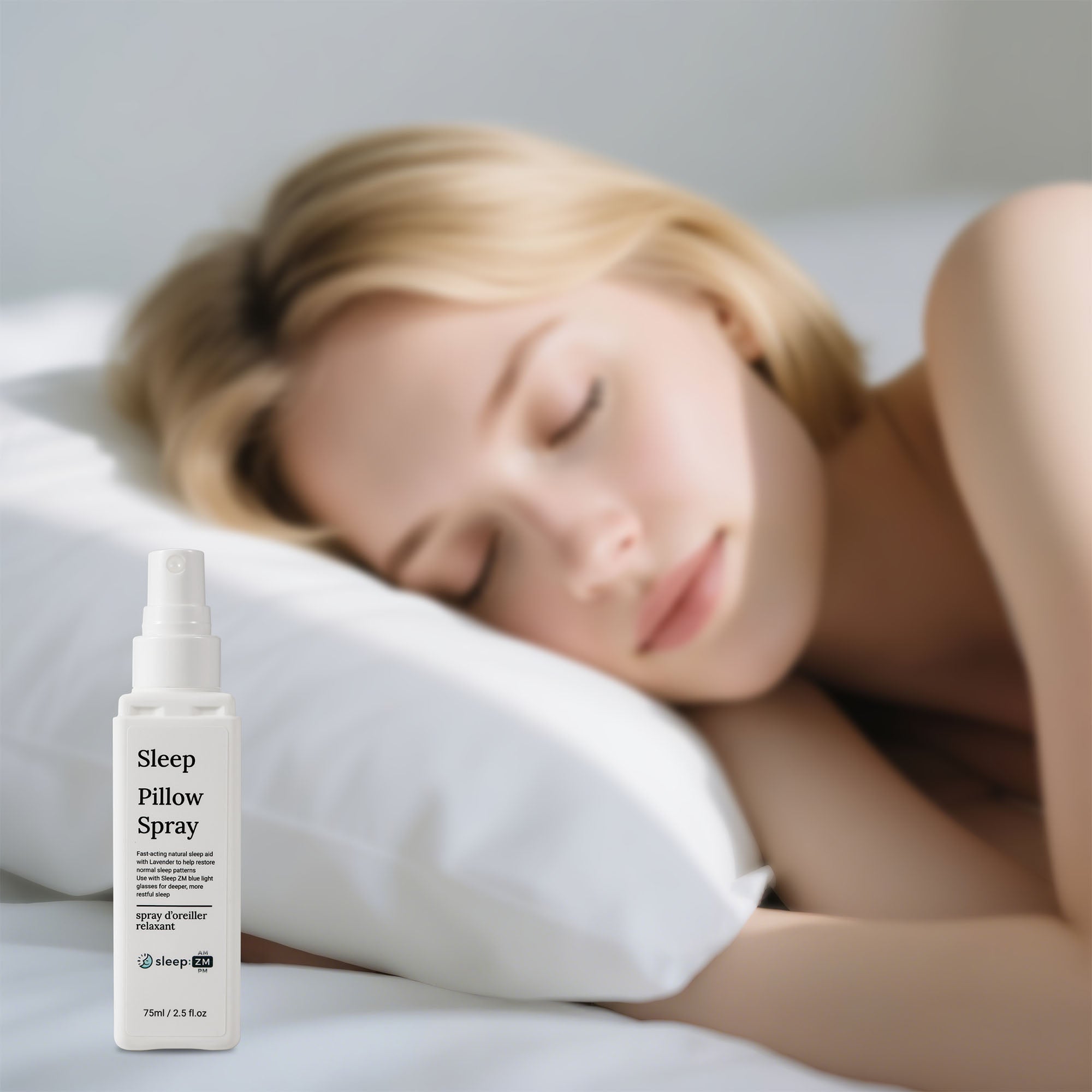 Woman sleeping with a bottle of Sleep Pillow Spray next to her on a pillow.
