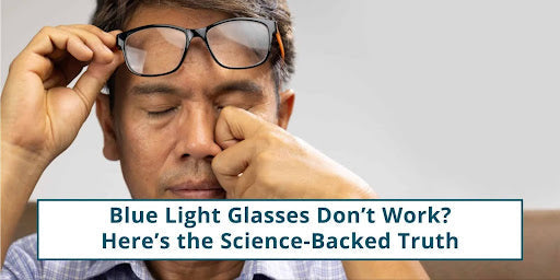 Tired man lifting his glasses to rub his eyes