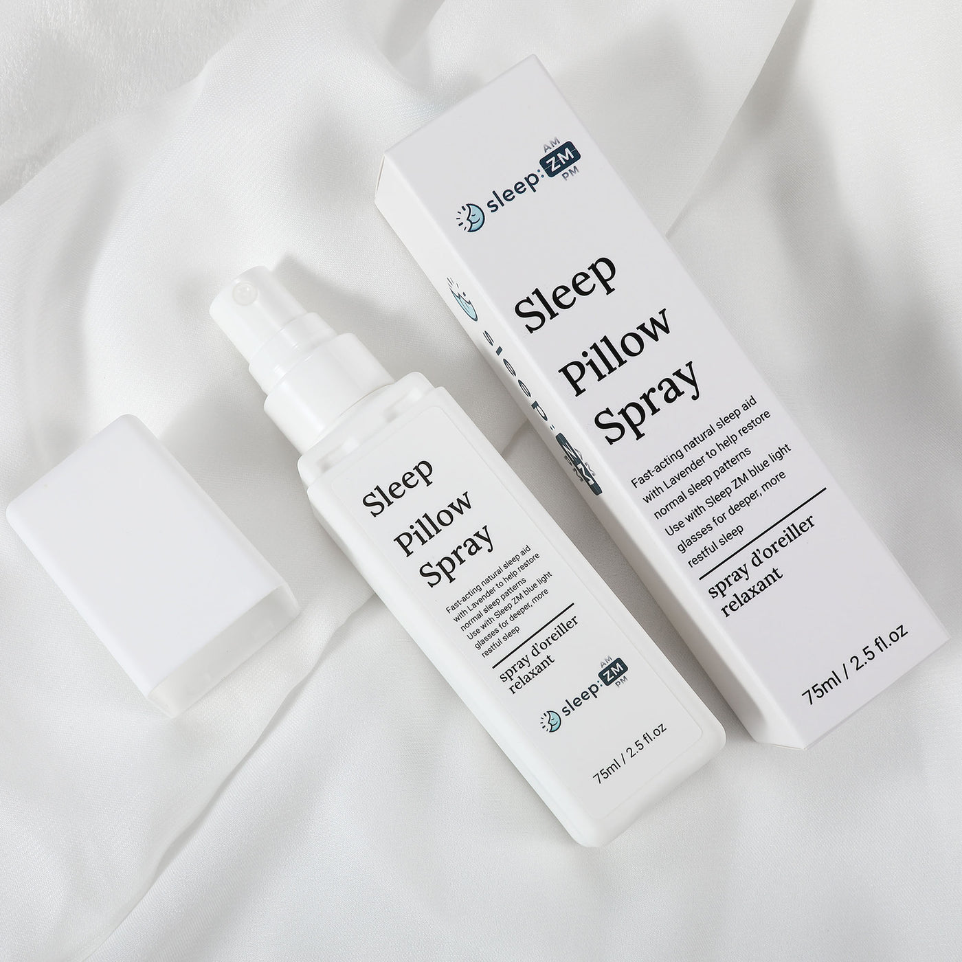 Sleep pillow spray bottle and packaging on a white fabric background