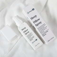 Sleep pillow spray bottle and packaging on a white fabric background